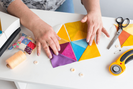 woman arranging quilts quotes about quilting